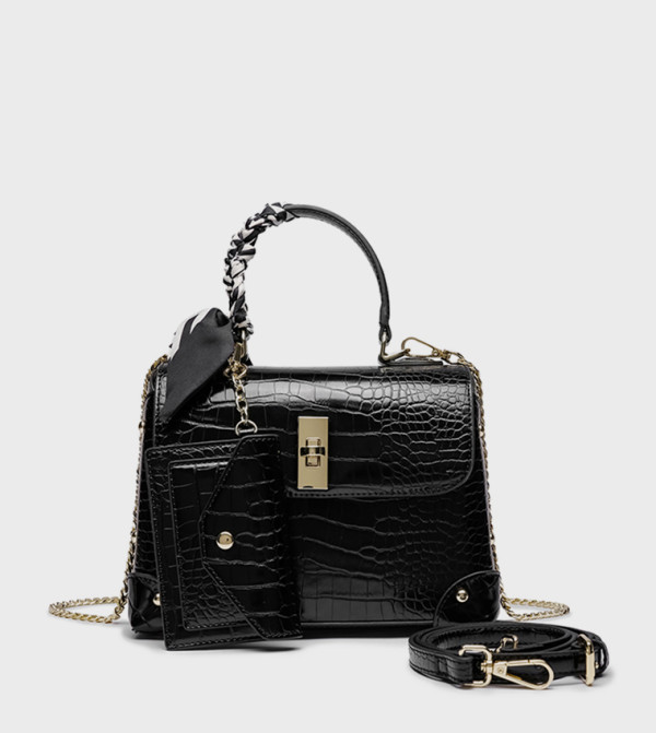 حقيبة بمقبض علوي ونقشة بارزة 