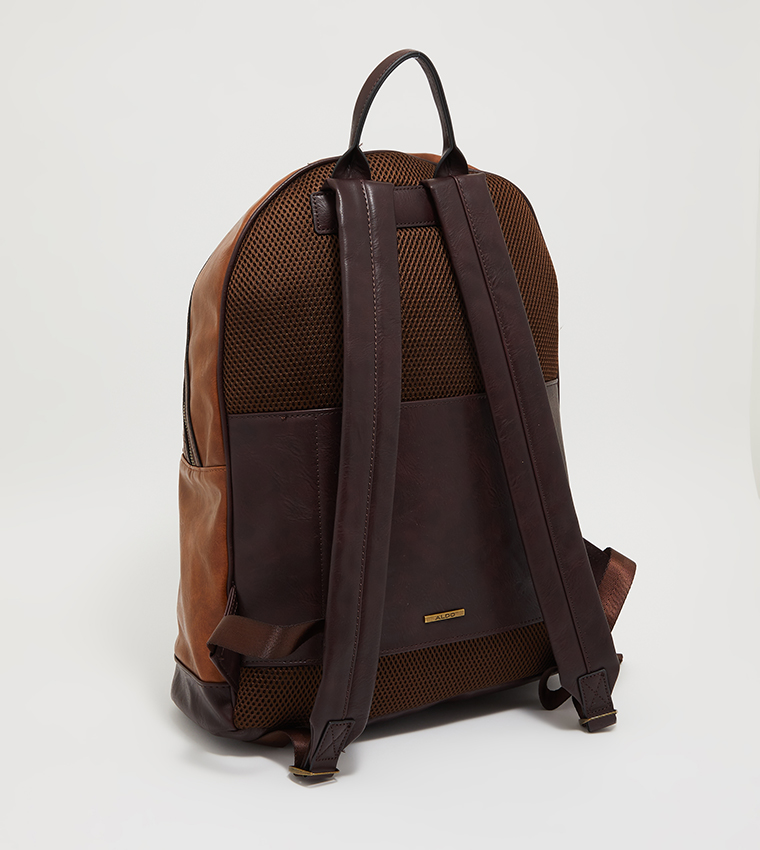 Round leather backpack with all-over embossed eagle