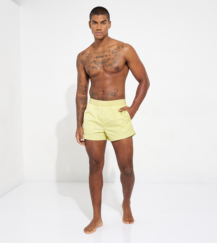 Buy Calvin Klein Logo Waistband Swim Shorts In Yellow 6thStreet UAE