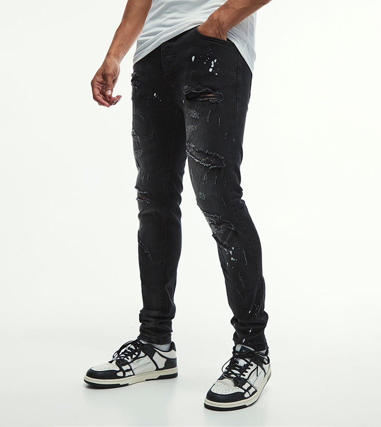 Buy BoohooMAN Stretch All Over Ripped Paint Splatter Skinny Fit Jeans In  Black | 6thStreet Bahrain