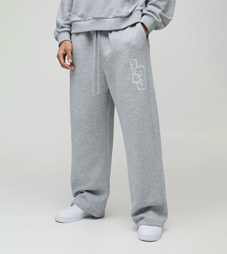Buy BoohooMAN Wide Leg Varsity Embroidered Drop Crotch Sweatpants
