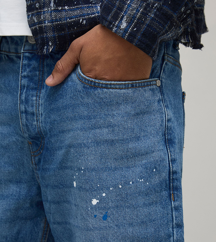Knee Rip and Repair Paint Splatter Slim Flared Jeans