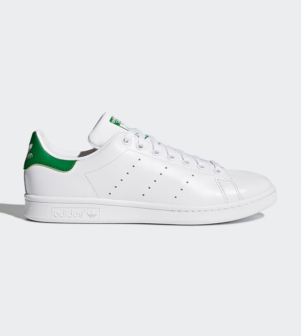 white tennis shoes with green back