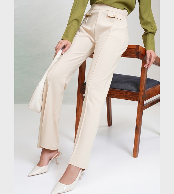Buy Tokyo Talkies Solid Mid Rise Flared Trousers In Off White