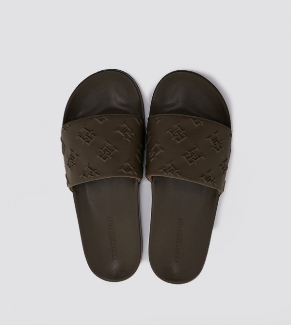 Tommy Hilfiger Embossed Monogram Slides in Black