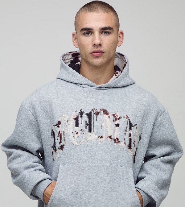 Ofcl Cow Print Applique Oversized Hoodie