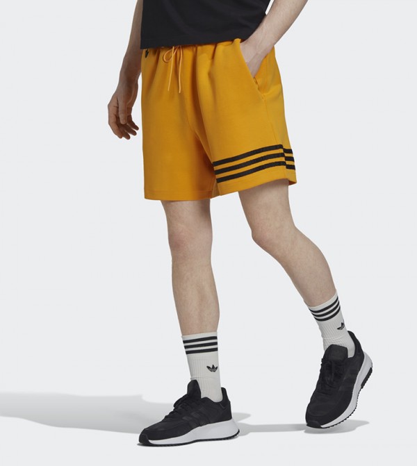 Adidas black shorts hotsell with yellow stripes