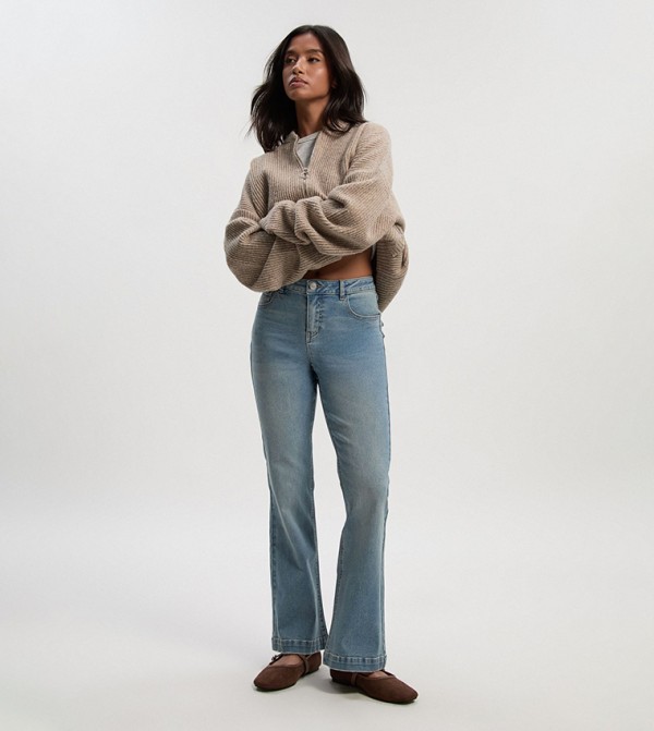 Petite Mid Rise Faded Flared Jeans