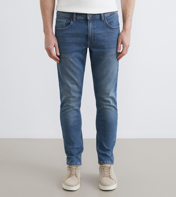 بنطلون جينز رجالي 750 مغسول بخصر متوسط وقصة ضيقة