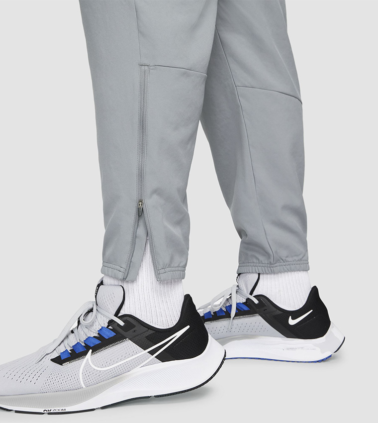 Buy Nike Dri FIT Challenger Woven Running Pants In Grey