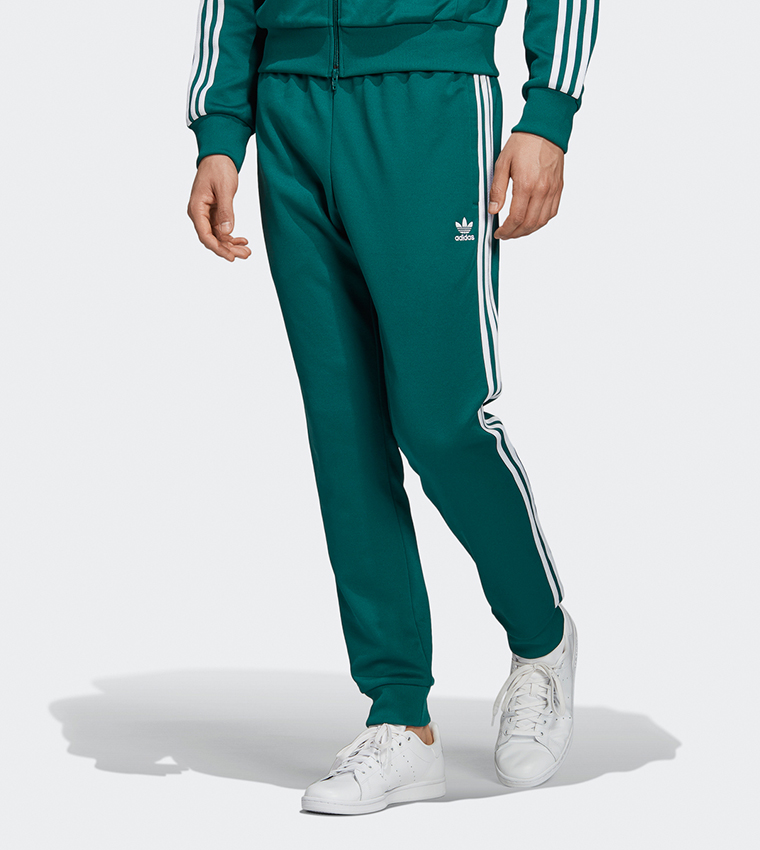 Adidas sst track pants noble best sale green