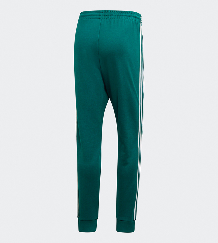 Adidas sst track pants noble green sale