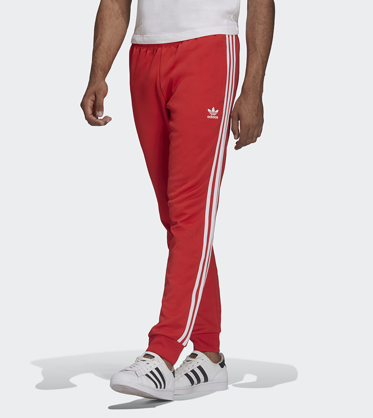 Buy Adidas Adicolor Classics SST Track Pants In Red