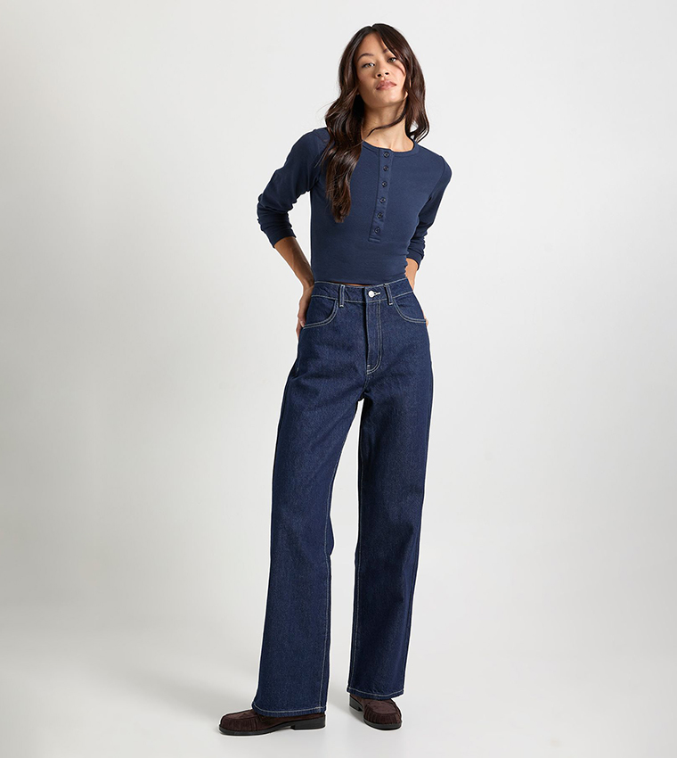 Indigo knit sweater with dark jeans